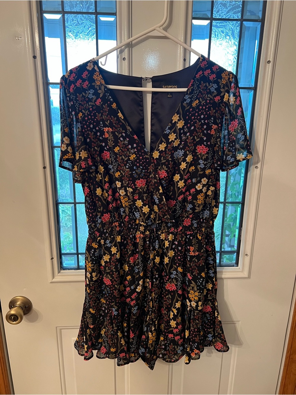 Floral V-Neck Black Romper with Ruffle Hem